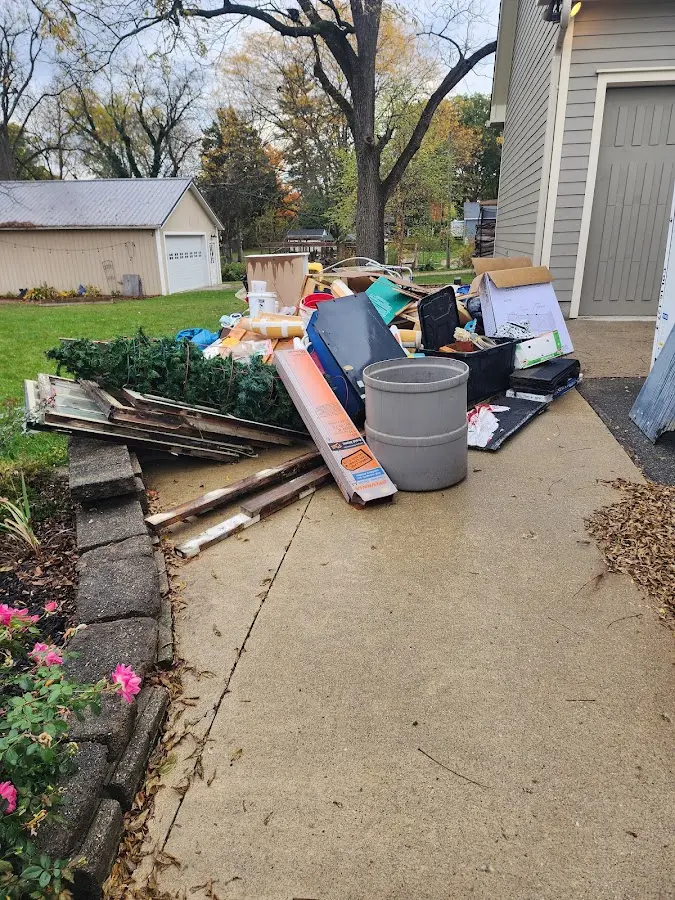 Dumpster being loaded with debris for Estate Cleanout Dumpster Rental in Sansom Park